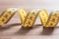 Soft Yellow Measuring Tape in Spiral Shape On A Table Royalty Free Stock Photo