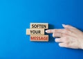 Soften your Message symbol. Concept words Soften your Message on wooden blocks. Beautiful blue background. Businessman hand.