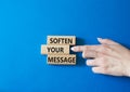 Soften your Message symbol. Concept words Soften your Message on wooden blocks. Beautiful blue background. Businessman hand.