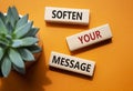 Soften your Message symbol. Concept words Soften your Message on wooden blocks. Beautiful orange background with succulent plant.