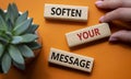 Soften your Message symbol. Concept words Soften your Message on wooden blocks. Beautiful orange background with succulent plant.