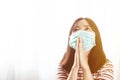Softfocus of Young woman in hygienic mask are praying