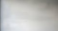 Softly blurred light grey background with subtle texture and gentle gradients of white and darker grey tones Royalty Free Stock Photo