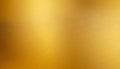 Softly blurred golden metallic surface with subtle brushed lines and warm light Royalty Free Stock Photo