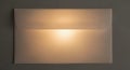 Simple square wall light fixture emitting a soft warm glow Royalty Free Stock Photo