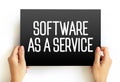 Software as a service is a software licensing and delivery model, text concept on card