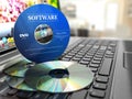 Software CD on laptop keyboard. Compact disks.