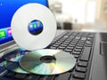 Software CD on laptop keyboard. Compact disks. Royalty Free Stock Photo