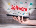 Software concept. Tablet computer in the hand. Old wooden background Royalty Free Stock Photo