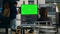 Software developer analyzing greenscreen and server code on multiple monitors