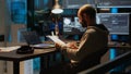 Software developer analyzing web data on clipboard papers and screens Royalty Free Stock Photo