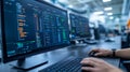 Software Developer Coding on Multiple Monitors Royalty Free Stock Photo