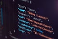 Software developer programming code. Abstract computer script code closeup on monitor screen with bokeh