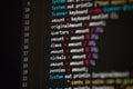Software developer programming code. Abstract computer script code closeup on monitor screen with bokeh