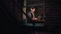Software Developer Programming on a Laptop Late Night. Male Specialist Browsing Internet, Listening Royalty Free Stock Photo