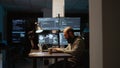 Software developer typing source code on laptop and multiple monitors Royalty Free Stock Photo