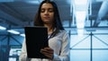 Software developer walking in data center, using tablet