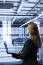 Software developer walking between server rows in data center