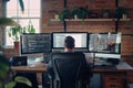 Software developer working from home using multiple monitors Royalty Free Stock Photo