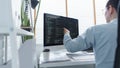 Software development concept, Male programmer checking data codes on document and computer screen