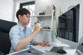 Software development concept, Male programmer checking website programming and drinking coffee
