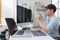 Software development concept, Male programmer checking website programming and drinking coffee