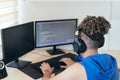 Software engineer sitting at desk and typing on computer keyboard while creating code while working at home Royalty Free Stock Photo