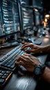 software engineer types code on keyboard, working with multiple monitors in dimly lit office
