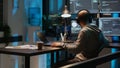 Software engineer typing programming code on laptop with multiple monitors Royalty Free Stock Photo