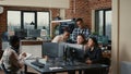 Software engineers brainstorming ideas looking at code on computer screens asking feedback