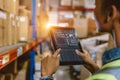 Software Smart warehouse management in tablet computer real time monitoring track goods package delivery. Inventory worker showing