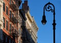 Soho building facades with cornices, fire escapes and a lamp-post. Manhattan, New York City Royalty Free Stock Photo