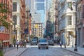 Soho street with cast iron buildings and people in New York