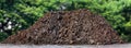 Soil clay mountain pile, soil heap land for construction home or road way building, wet soil dirt mound brown black large pile