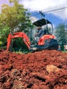 Soil close up blurred backhoe to renovate the site in preparation for pouring the concrete slab