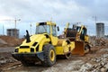 Soil Compactor and bulldozer at construction site Royalty Free Stock Photo