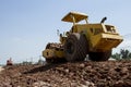 The soil compactor is in the work area.Road roller equipped with padfoot drum