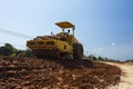 The soil compactor is in the work area.Road roller equipped with padfoot drum