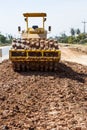 The soil compactor is in the work area.Road roller equipped with padfoot drum