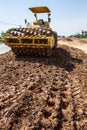 The soil compactor is in the work area.Road roller equipped with padfoot drum