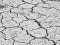 Large stretches of cracked dry soil, a view of the bottom of a drained lake without water.