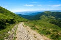 Soil road in mountains on background blue sky in summer Royalty Free Stock Photo