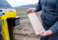 Soil Sampling. An engineer employee of a research laboratory packs a soil sample in a paper package. Automated probe for soil