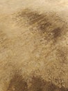 Soil texture, dirt road or dry mud, of different shades of brown. Dry cracked sand abstract background, Rough brown red earth Royalty Free Stock Photo