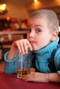 Soiled boy drinks juice from glass Royalty Free Stock Photo