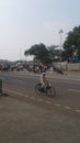 An old man with white cap drives cycle on sunny days