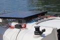 Solar battery for the development of electric current under the influence of sunlight mounted on the deck of a small sailing yacht