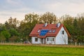 Solar battery on the roof of a rural house under a blue sunny sky. solar energy, alternative electricity Royalty Free Stock Photo