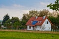 Solar battery on the roof of a rural house under a blue sunny sky. solar energy, alternative electricity Royalty Free Stock Photo