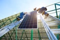 Solar battery screen installing by two mounters. Royalty Free Stock Photo